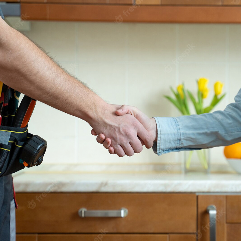 Man and woman shaking hands in a kitchen