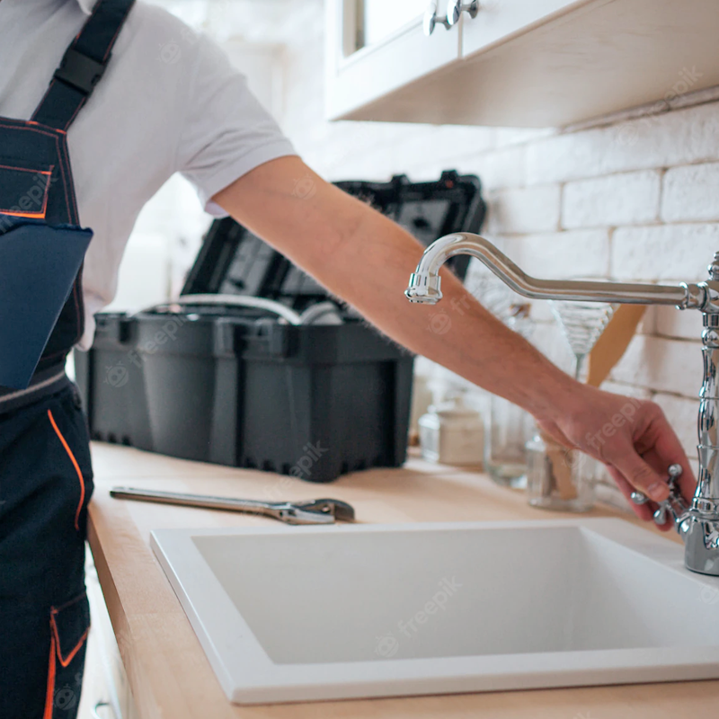 Plumber working on a sink